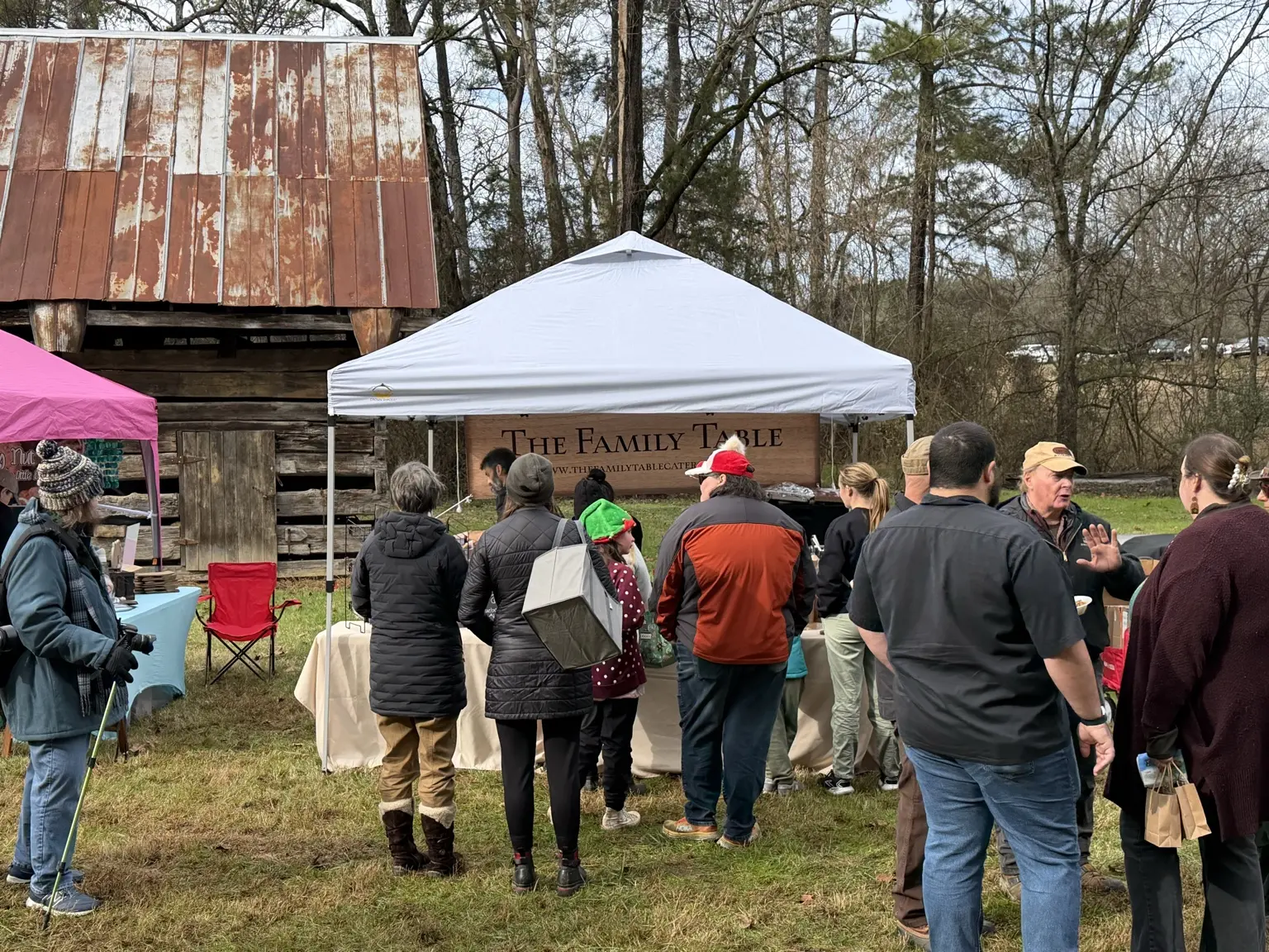 Guests gathered around the Family Table Catering booth
