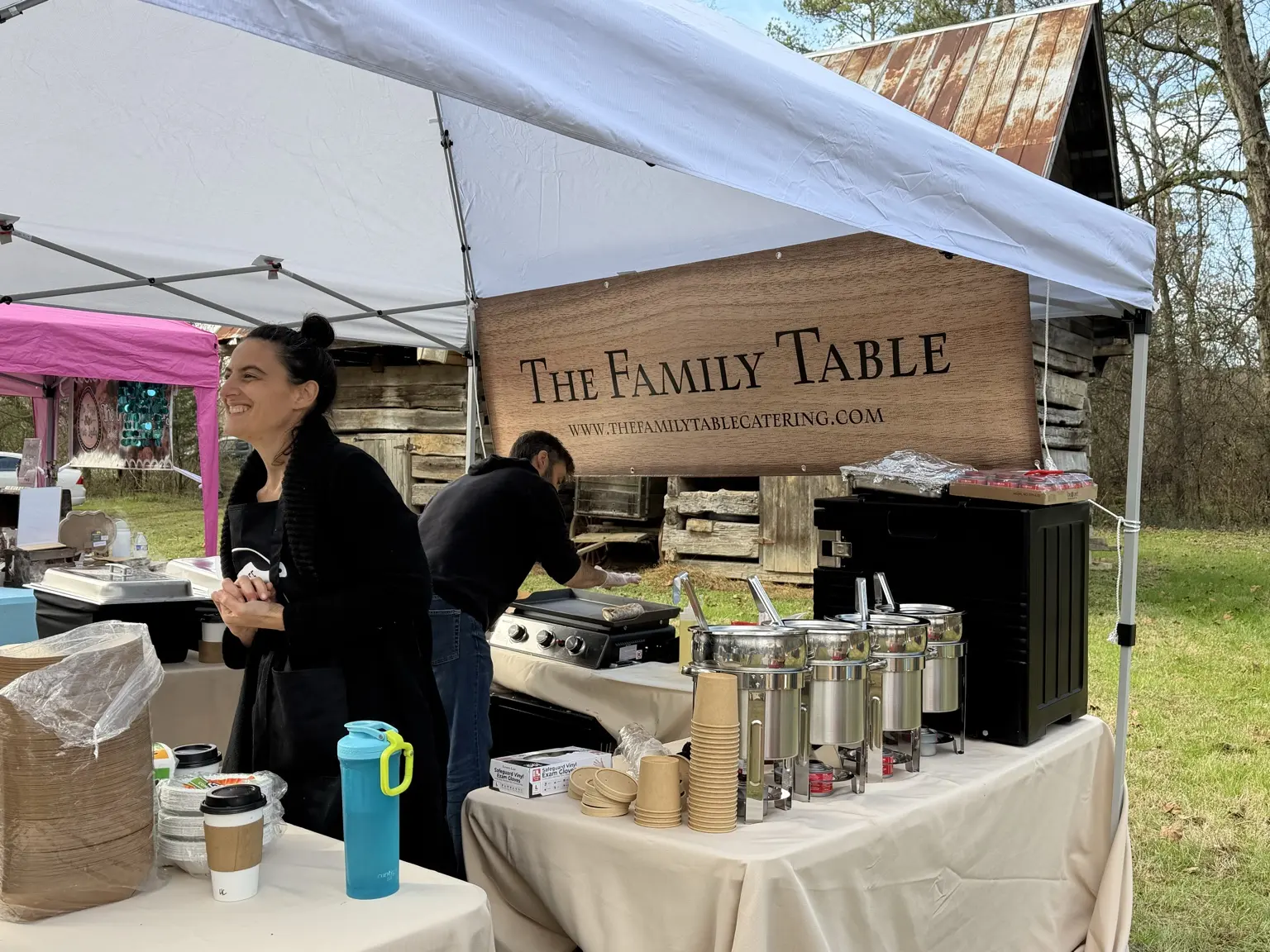 Gaetano and Lauren serving guests at an outdoor event